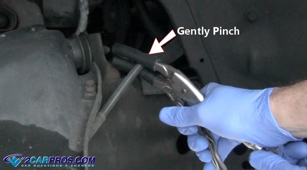gently pinch rubber brake line
