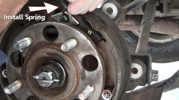 installing parking brake return spring upper front