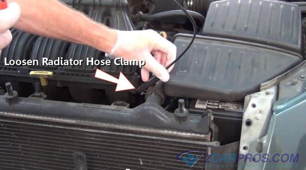 loosen upper radiator hose clamp