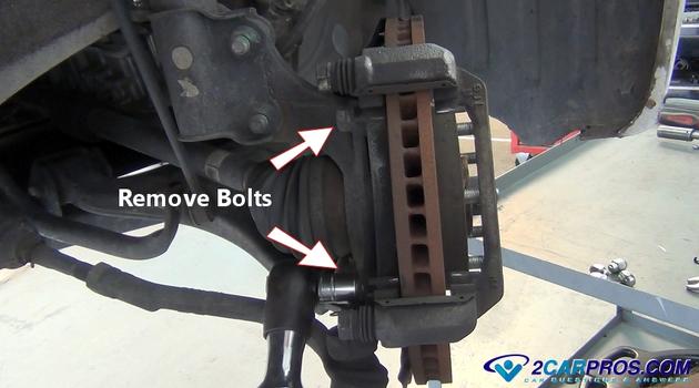remove caliper mounting bracket bolts