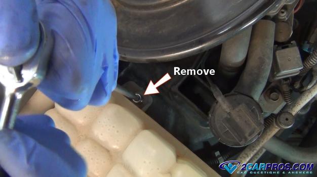 remove coolant reservoir mounting bolts