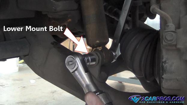 remove lower shock mount bolt